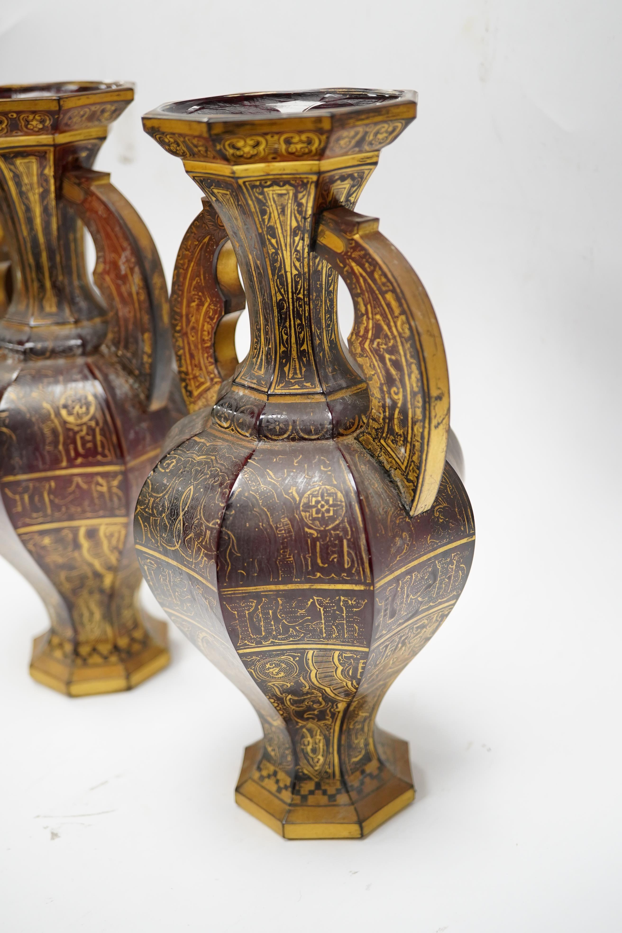 A pair of Venetian Islamic inspired gilt decorated ruby glass twin handled vases, 24cm high. Condition - wear to gilding on both vases